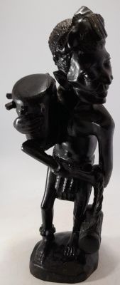 LARGE HEAVY HARDWOOD ETHNIC MAN CARRYING 2 PERCUSSION DRUMS 14 INCHES IN HEIGHT