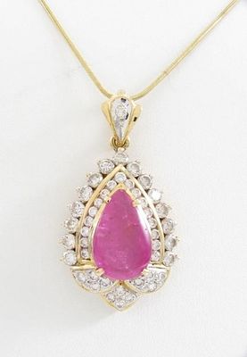 14K Yellow Gold Ruby, Diamond Pendant, Chain. A 14K yellow gold pear shaped pendant containing a 