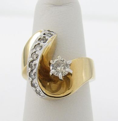 14K Yellow Gold Diamond Fashion Ring. A 14K yellow gold free form fashion ring featuring an 