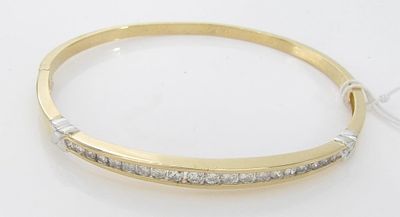 14K Yellow Gold Diamond Bangle Bracelet. A 14K yellow gold bangle bracelet with "X" motif 