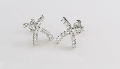 14K White Gold Diamond X Earrings. A pair of 14K white gold "X" earrings with thirty-two round 