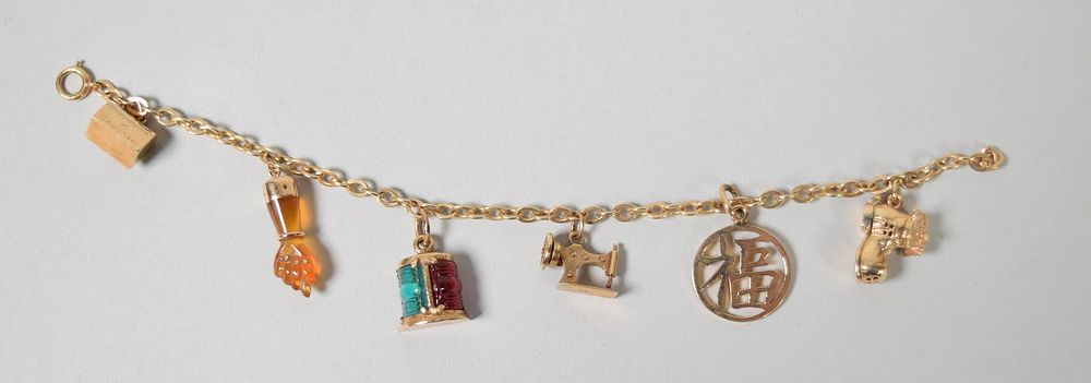 Lot 247: 14k Gold Charm Bracelet