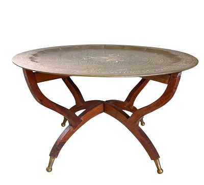 Bohemian Round Brass Tray Table. Bohemian round brass tray table with an etched surface resting 
