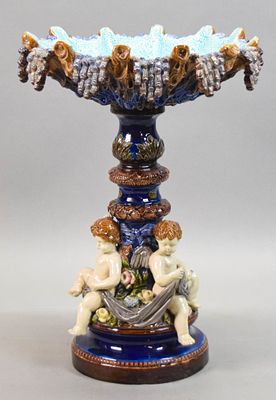 Figural Majolica Center Piece. Figural majolica centerpiece, with three seated Putti on the 