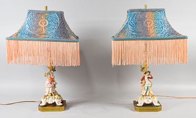 Pair of German Porcelain Figural Table Lamps. A pair of decorative table lamps featuring 