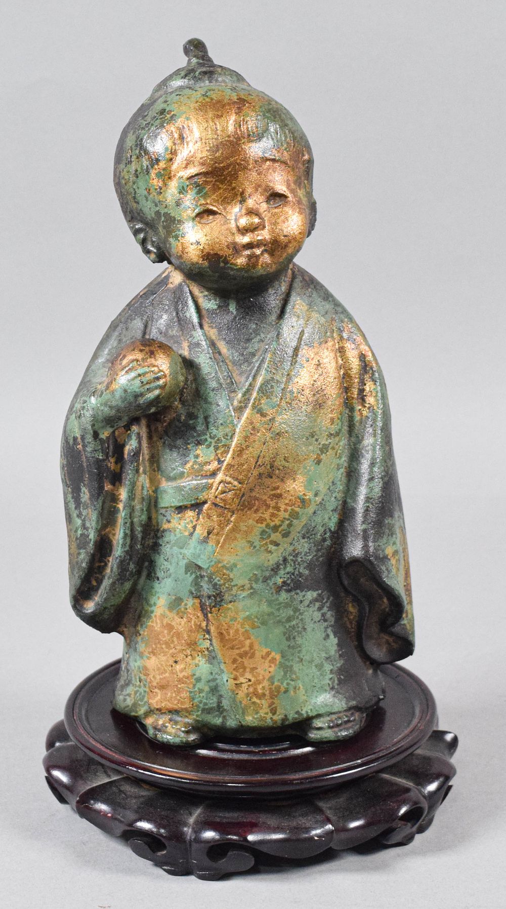 Lot 172: Japanese Cast Iron Okimono of a Child with Wooden Stand