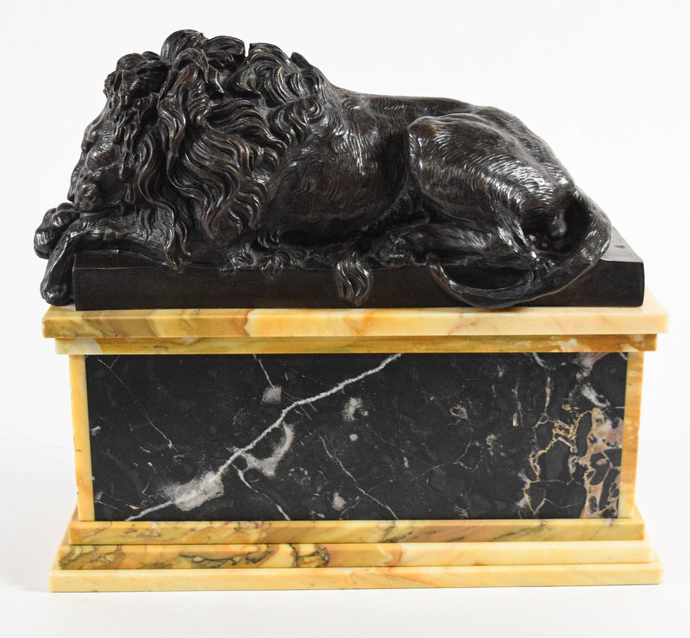 Lot 227: A Bronze Sculpture of a Reclining Lion on a Giallo Antico and Portoro Marble Pedestal