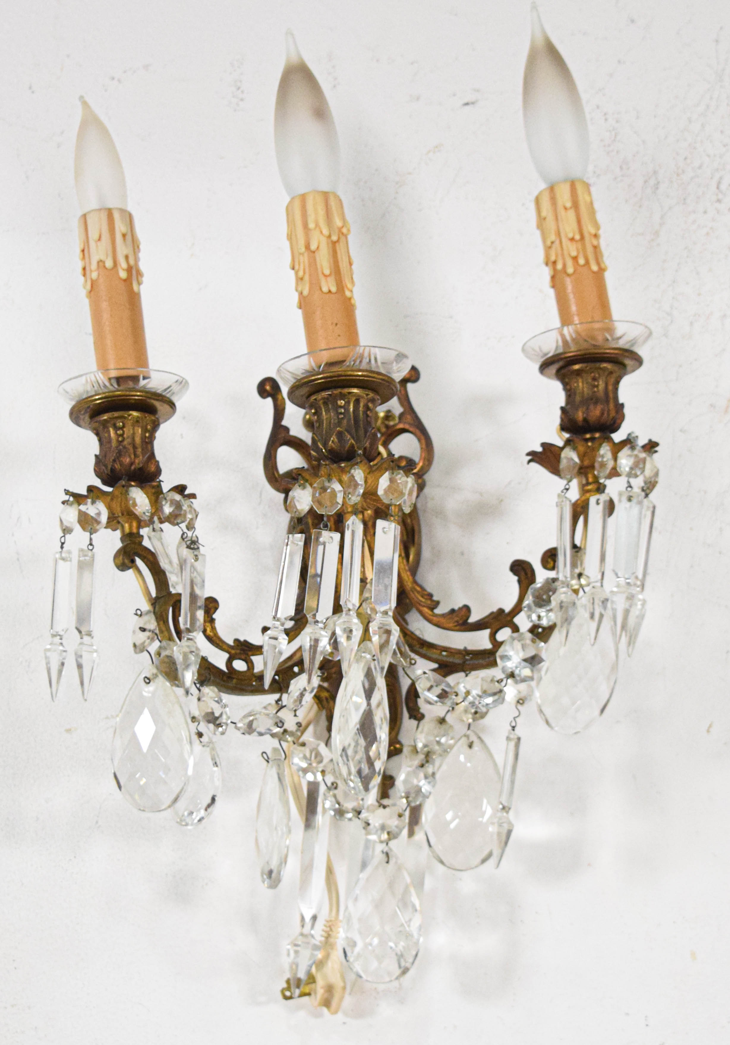 A Pair of French Style Bronze and Crystal Three-Light Wall Sconces