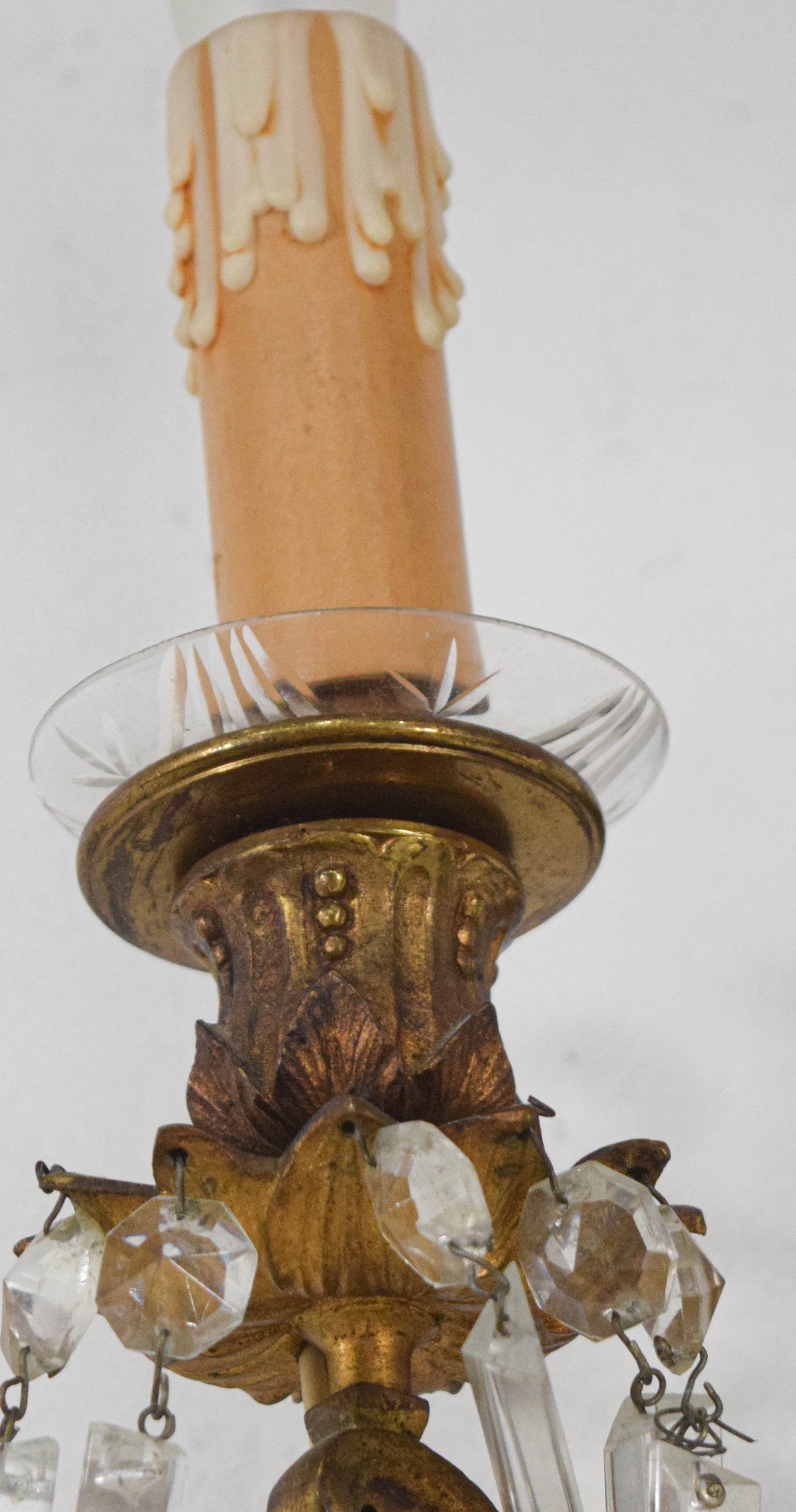 A Pair of French Style Bronze and Crystal Three-Light Wall Sconces