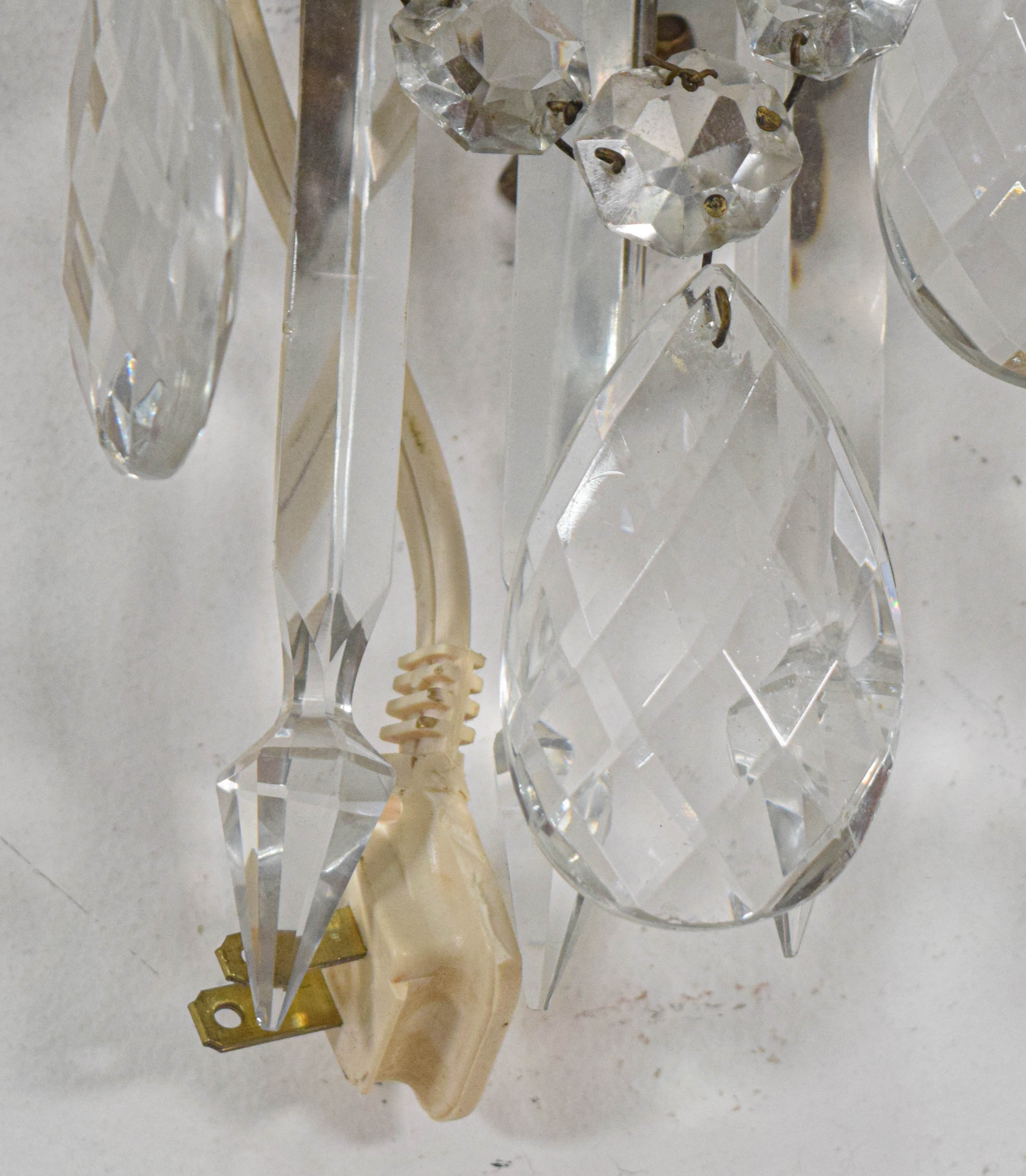 A Pair of French Style Bronze and Crystal Three-Light Wall Sconces