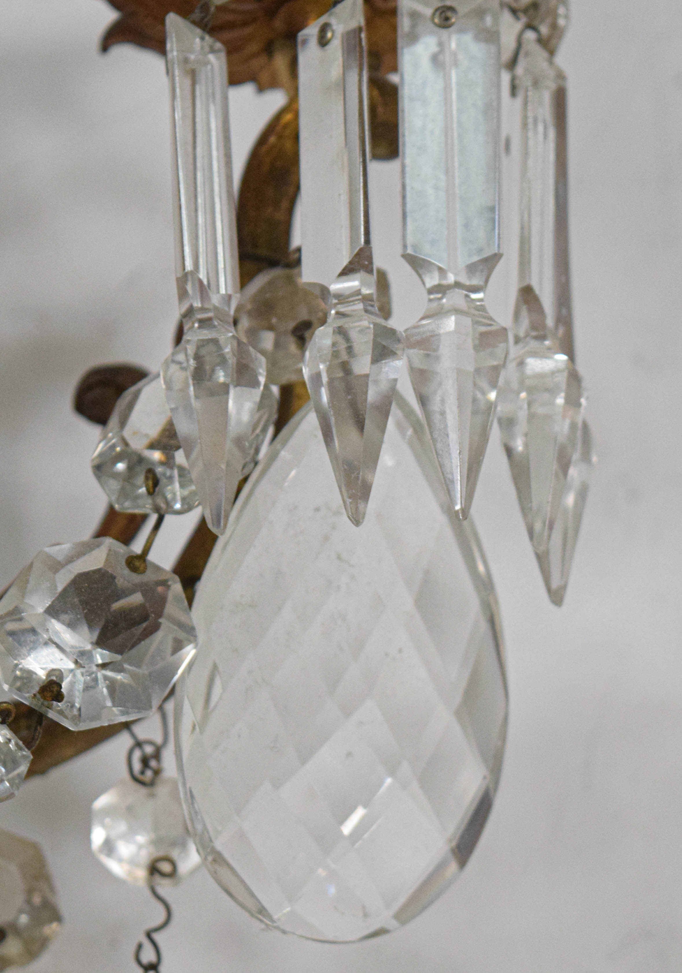 A Pair of French Style Bronze and Crystal Three-Light Wall Sconces