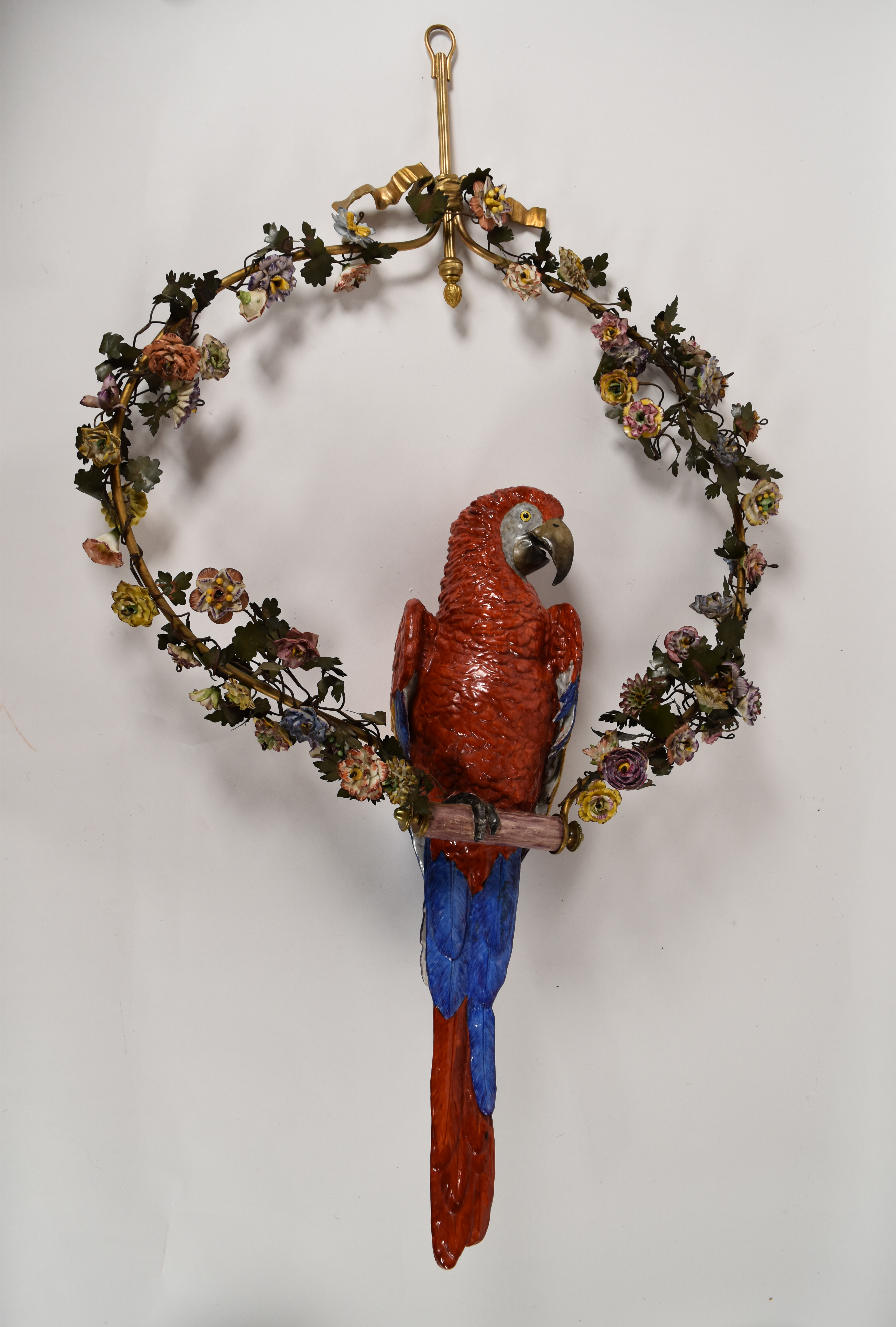 Large Porcelain Scarlet Macaw Within A Floral Wreath and Gilt Wall Bracket
