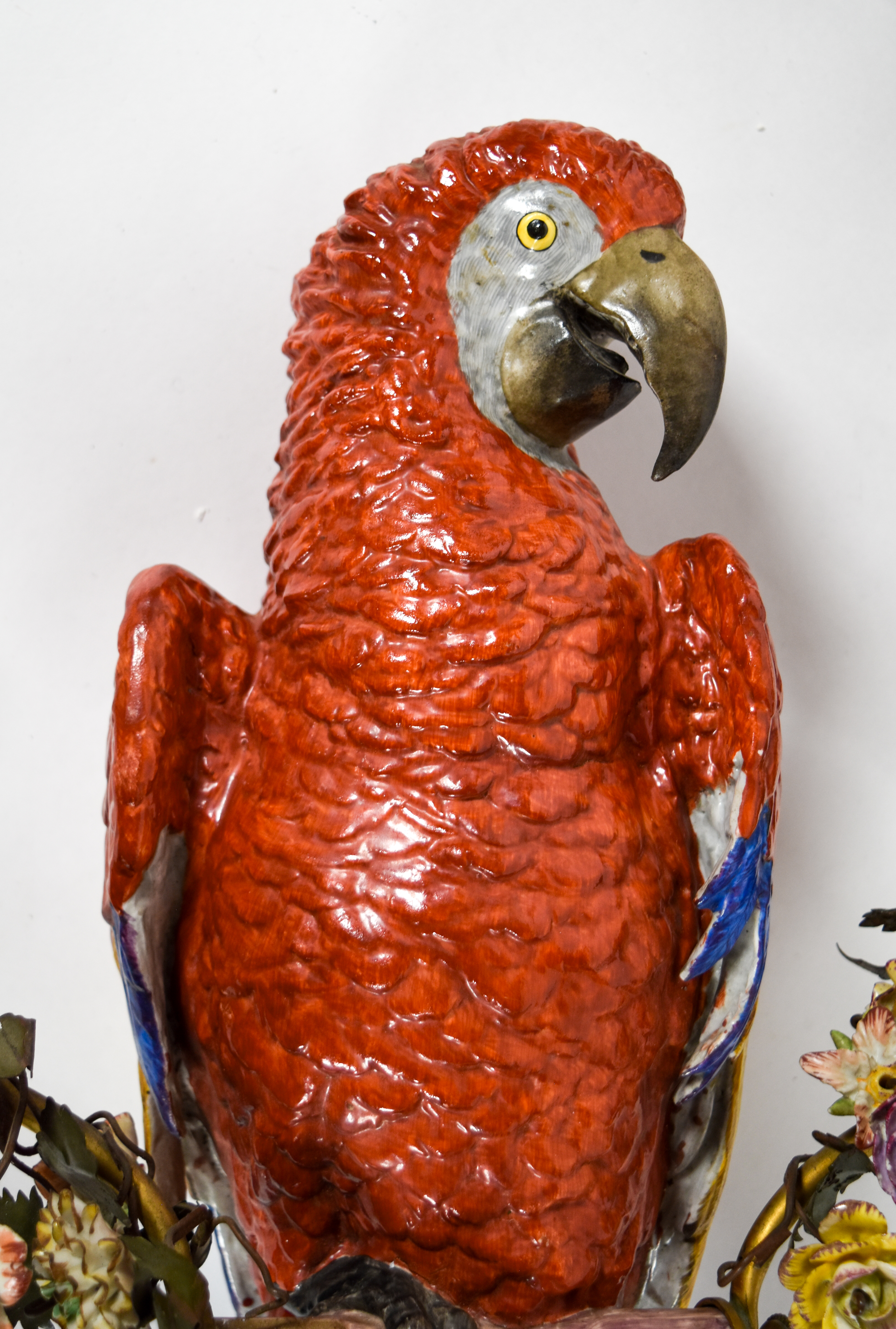 Large Porcelain Scarlet Macaw Within A Floral Wreath and Gilt Wall Bracket