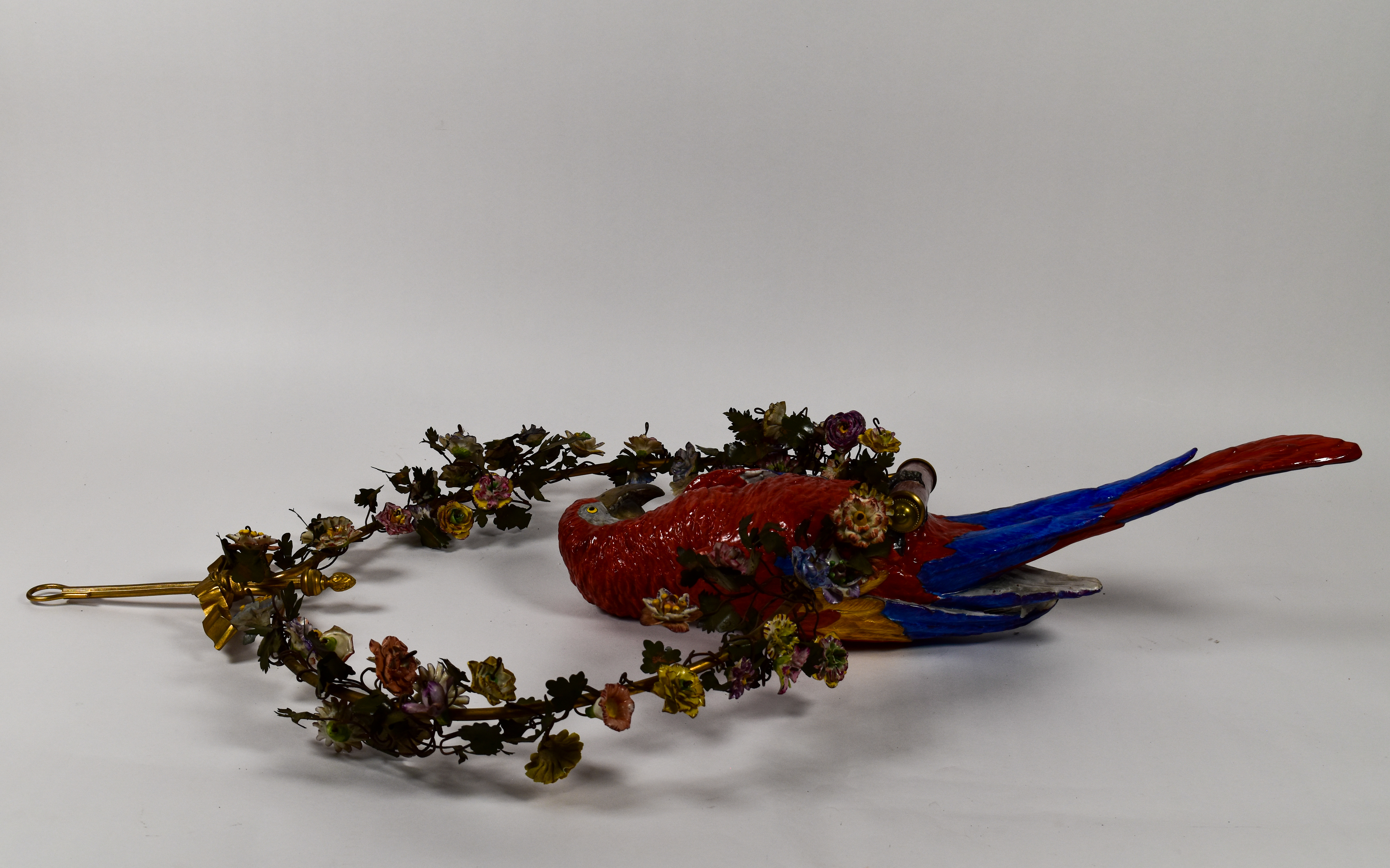 Large Porcelain Scarlet Macaw Within A Floral Wreath and Gilt Wall Bracket