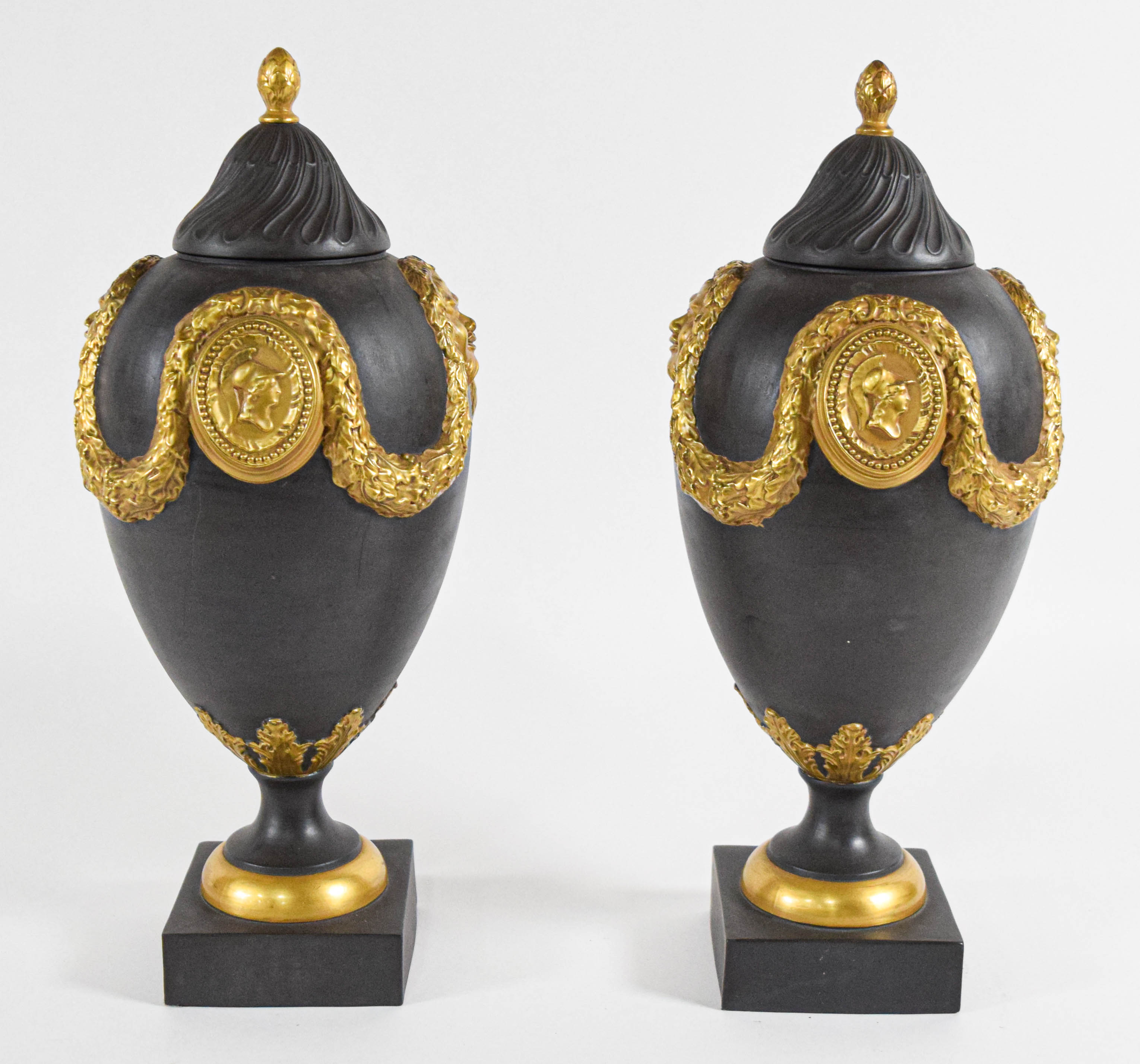 A Pair of Mottahedeh Neoclassical Style Gilded Black Basalt Lidded Urns