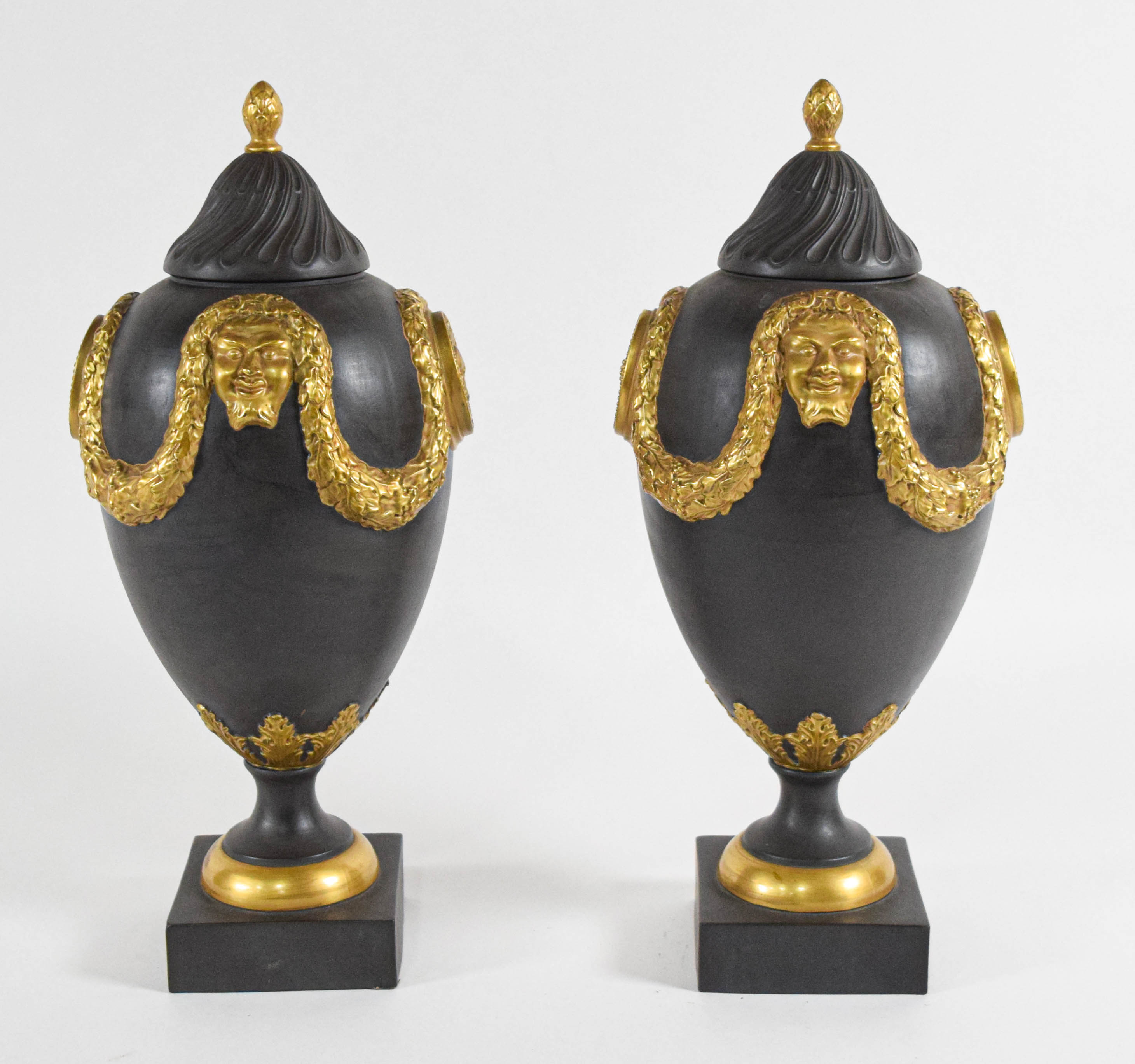 A Pair of Mottahedeh Neoclassical Style Gilded Black Basalt Lidded Urns