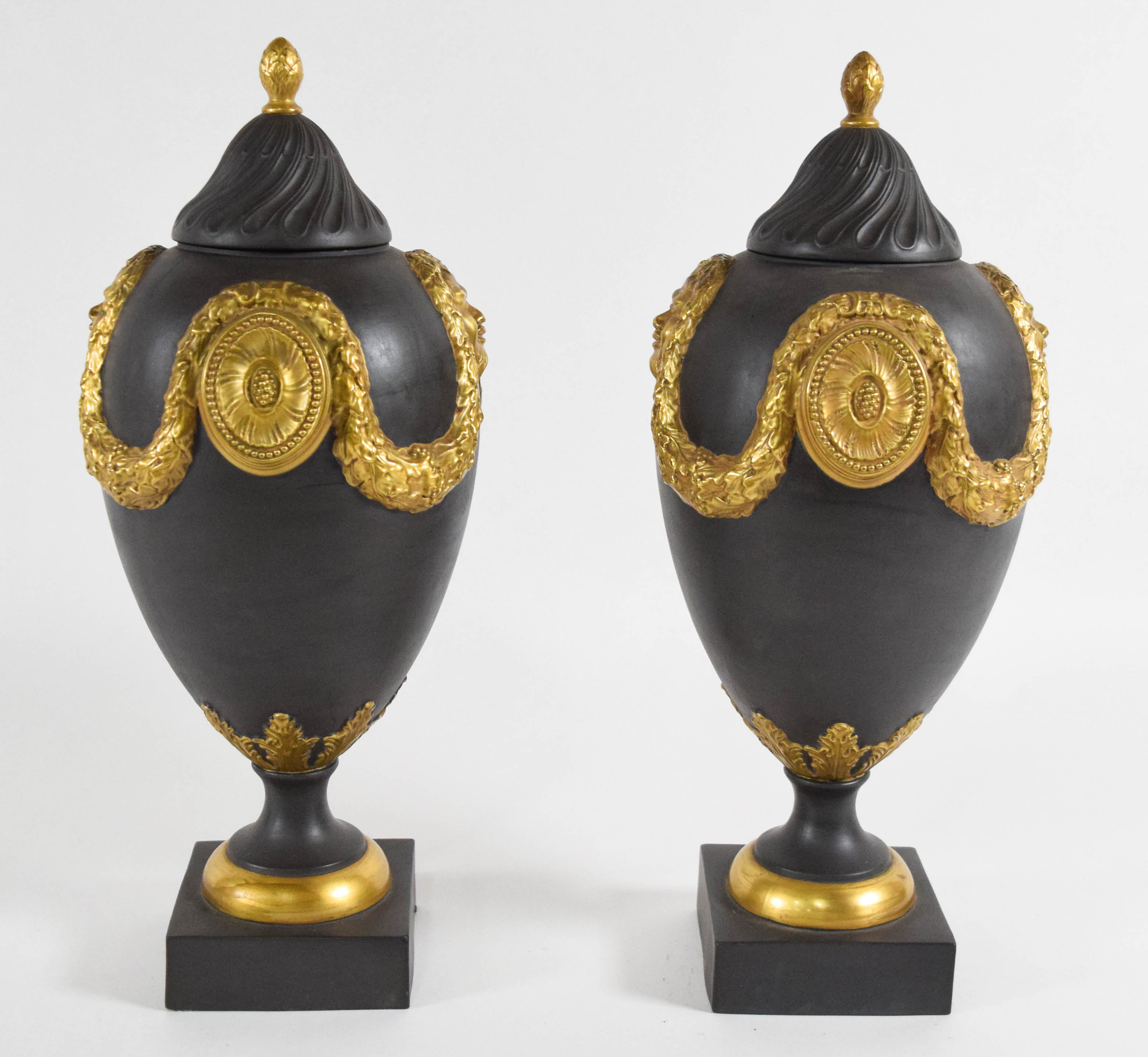 A Pair of Mottahedeh Neoclassical Style Gilded Black Basalt Lidded Urns