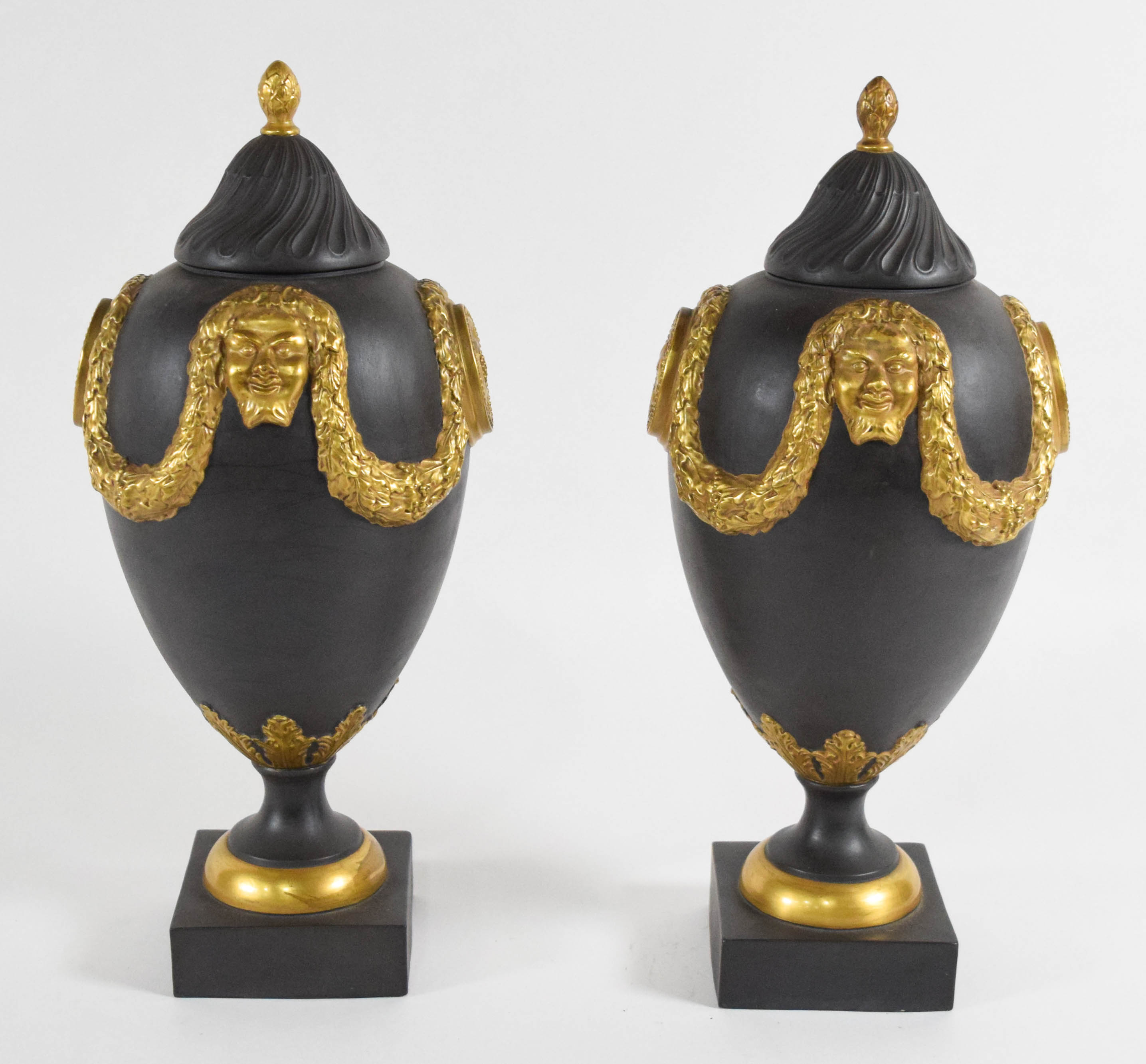 A Pair of Mottahedeh Neoclassical Style Gilded Black Basalt Lidded Urns