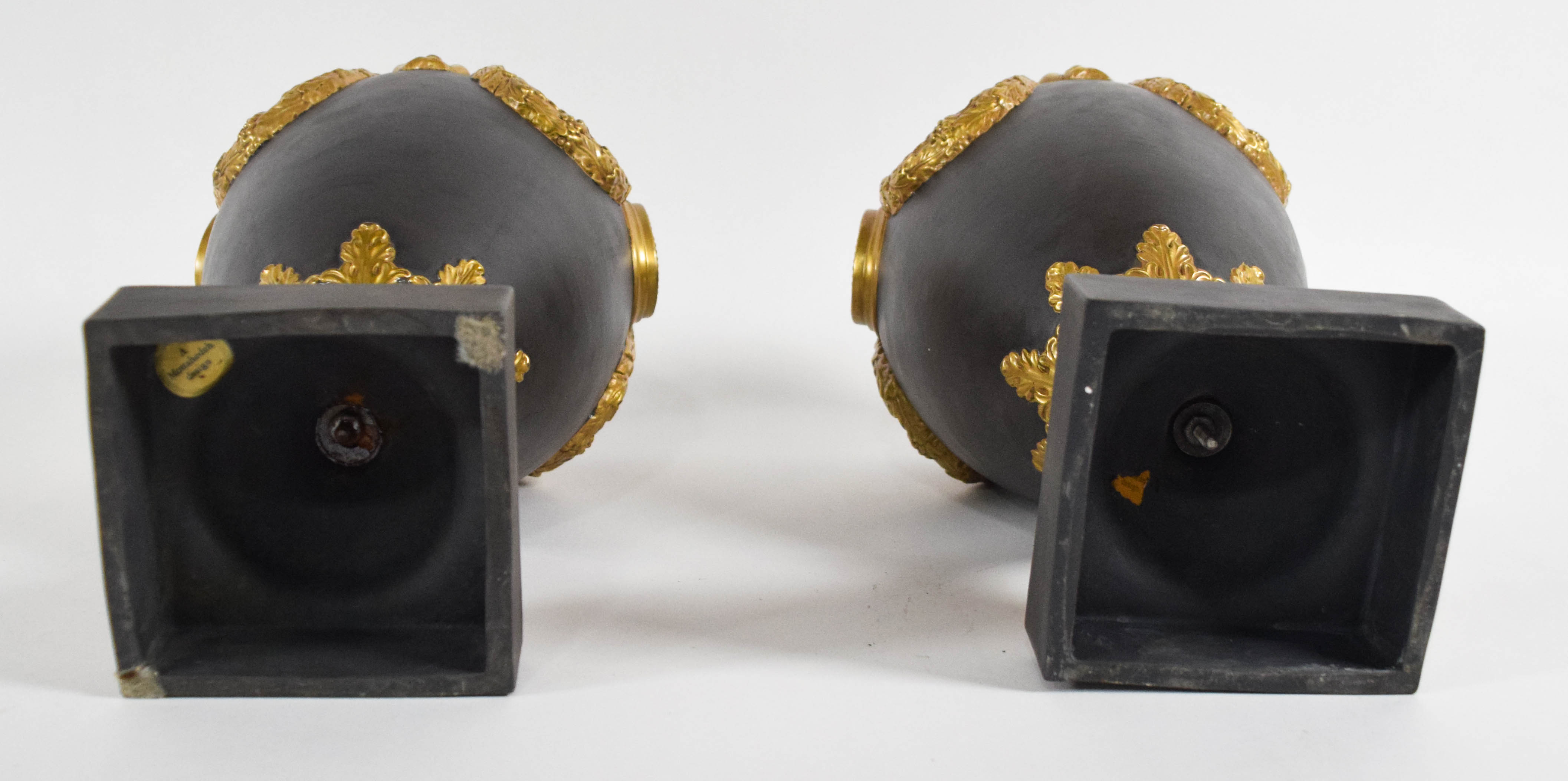 A Pair of Mottahedeh Neoclassical Style Gilded Black Basalt Lidded Urns