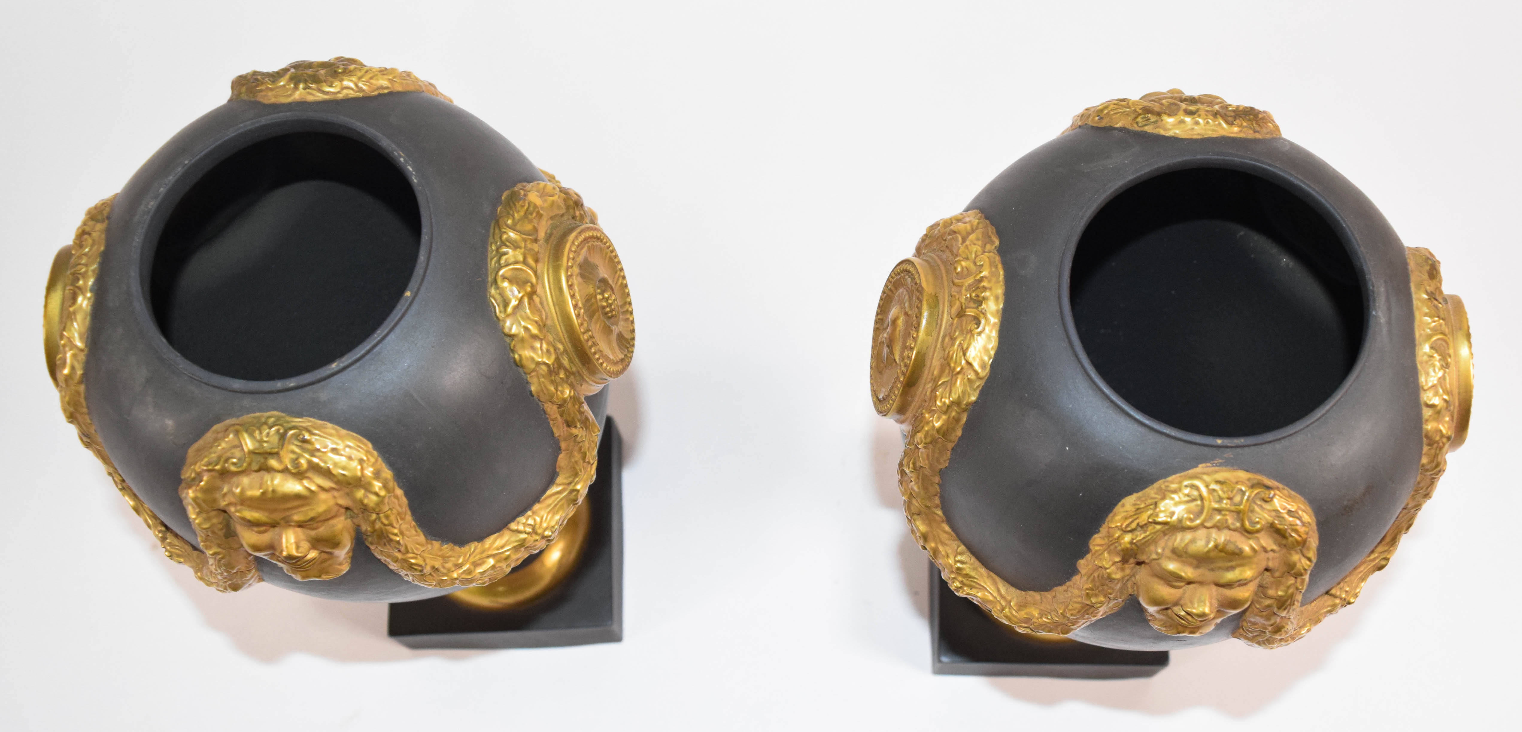 A Pair of Mottahedeh Neoclassical Style Gilded Black Basalt Lidded Urns