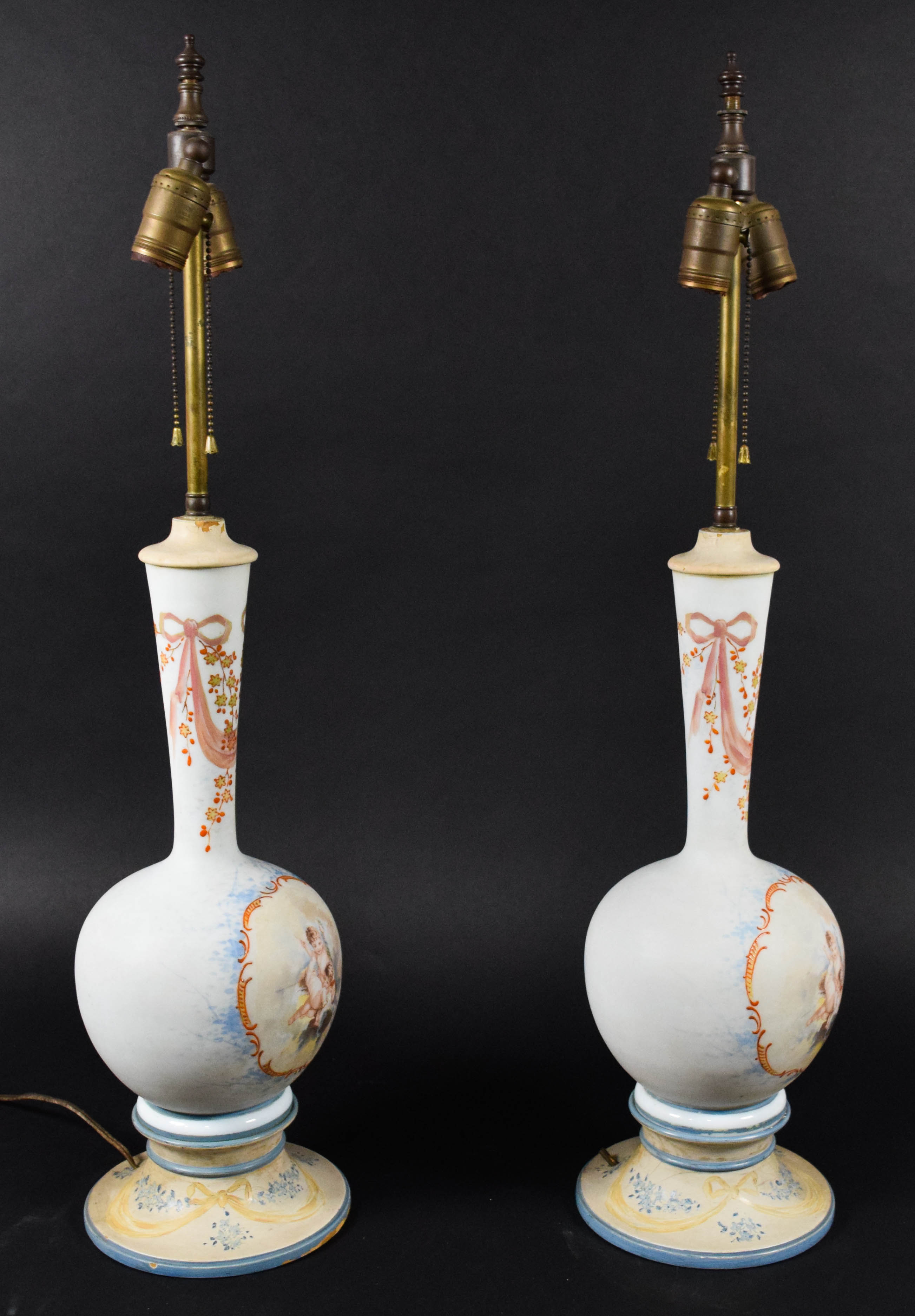 A Pair of Neoclassical Style Porcelain Vase Form Table Lamps with Cherub Decoration