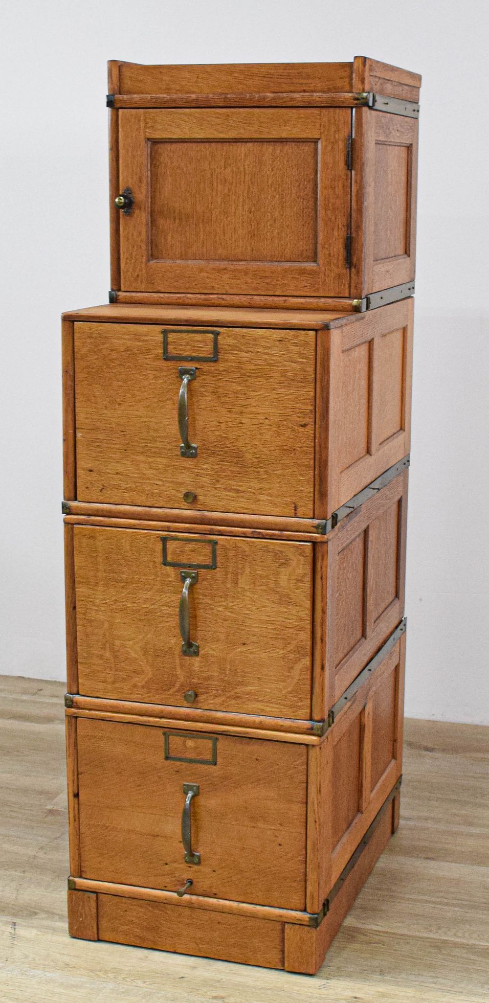Lot 411: A Modular Four-Section Oak Filing Cabinet and Footstool