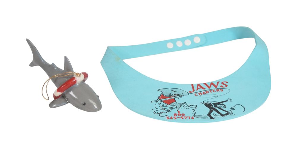 Lot 155: 2 Shark Souvenirs Including an Ornament and Jaws Charters Foam Visor