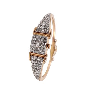 Art Deco 18kt Gold Bangle Universal Geneve Watch with 4.40 CTW in Diamonds. This exquisite circa 