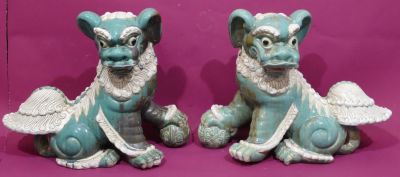 A pair of Oriental green glazed earthenware figures of Dogs of Foo, 53.5cm high, 68cm wide 
