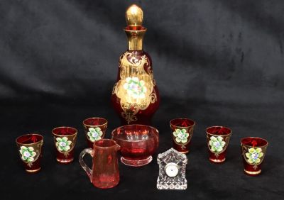 A Continental ruby glass liqueur decanter with stopper and allover gilt and floral decoration 