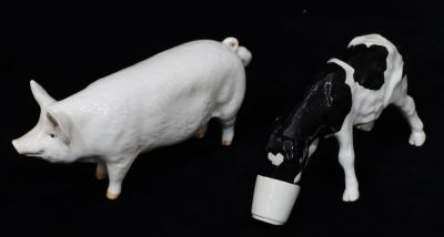 A Shebeg, calf drinking from a pail with ears back, signed M A Mooney, 15cm long, a Beswick "C 