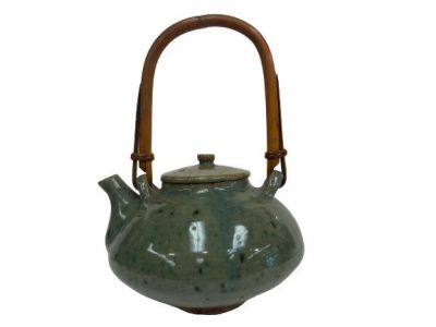Antique Asian Teapot with bamboo handle and a glazed surface. Condition: Good Used condition 
