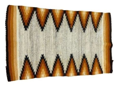 A NAVAJO WEAVING HAND WOVEN FLAT TRIBAL BLANKET RUG. A unique tribal weaving with multiple 