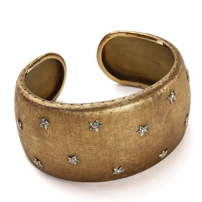 GOLD CUFF BRACELET WITH DIAMOND-SET STAR MOTIFS. Dimensions: Inner diameter: 2 1/4 in. (5.8 cm) 