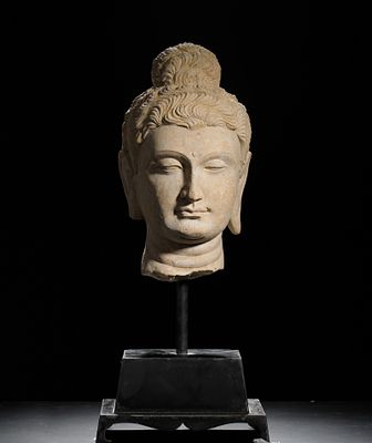 3RD CENTURY STONE-CARVED GANDHARA HEAD. H:55CM (21.65IN) H:32CM (12.60IN) W:18CM (7.09IN) 
