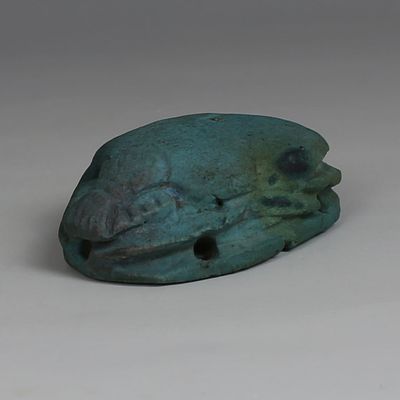 Egyptian scarab from mummy wrappings. ITEM: Scarab from mummy wrappings MATERIAL: Faience 